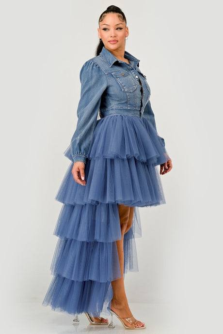 Woman wearing a blue denim dress with a tulle skirt on a white background