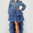Woman wearing a denim dress with a layered tulle skirt on a white background
