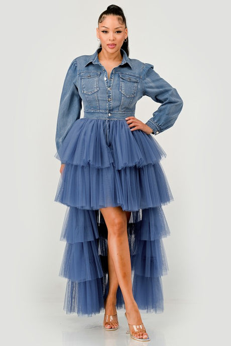 Woman wearing a denim dress with a layered tulle skirt on a white background