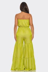 back view of Woman wearing a strapless yellow jumpsuit on a white background