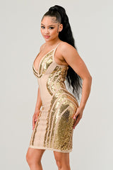 Woman wearing a gold sequin dress on a plain background