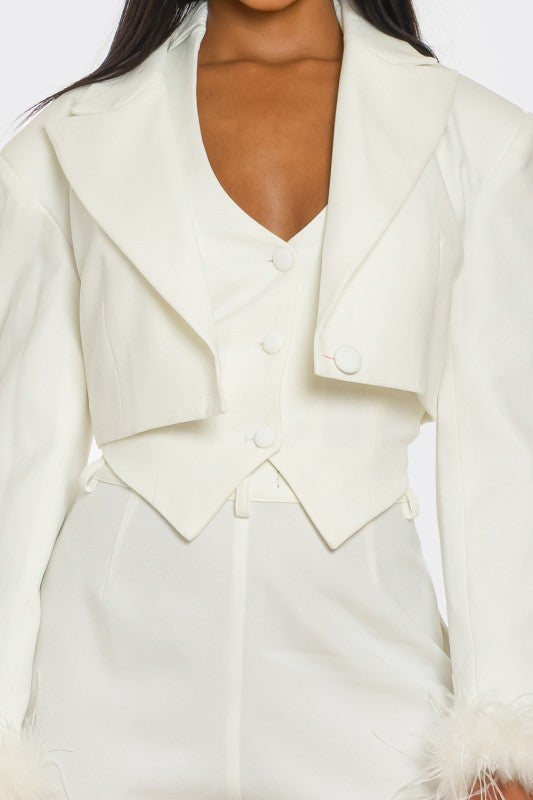 White blazer with fur cuffs on a white background