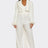 Woman wearing a white suit on a white background