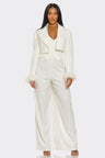 Woman wearing a white suit on a white background