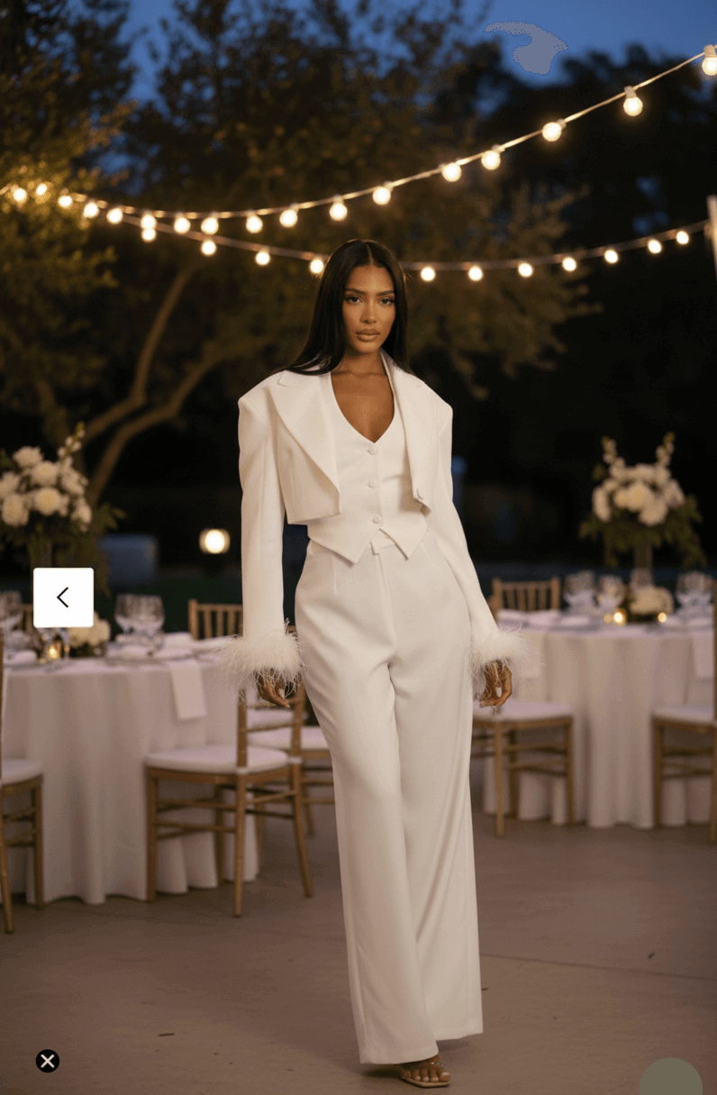 Woman in a white outfit standing in an outdoor setting with string lights and tables in the background.