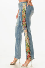 Denim jeans with floral patchwork on a white background