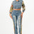 Woman wearing a denim jacket and jeans with floral sleeves on a white background