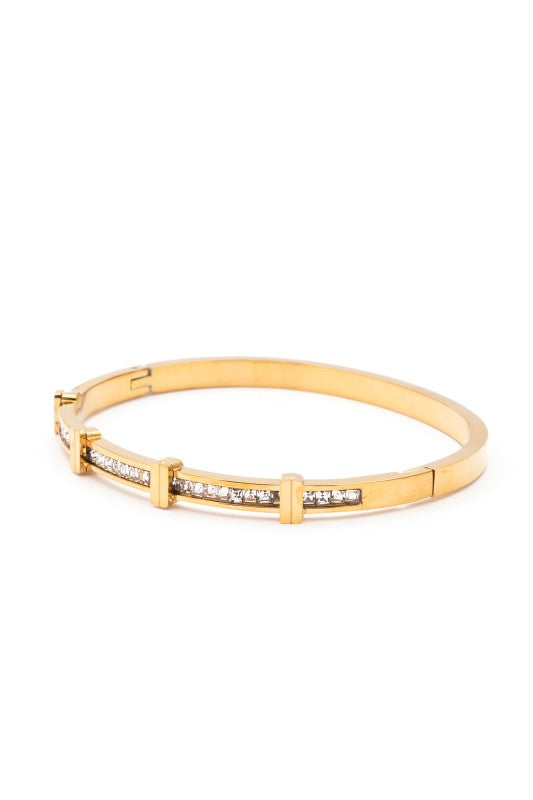 Gold bracelet with embedded stones on a white background