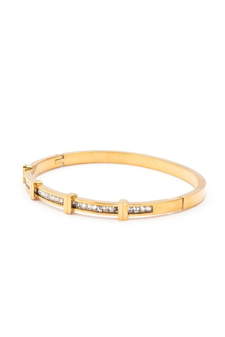 Gold bracelet with embedded stones on a white background
