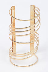 product Gold metal bracelet with a Unique spiral design. Bold statement piece