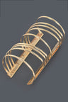 Gold metal bracelet with a Unique spiral design. Bold statement piece