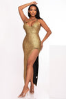 Woman wearing a gold sequin dress with a high slit on a white background
