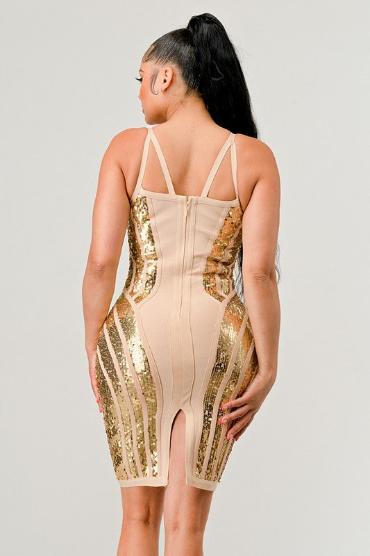 Beige dress with gold sequin accents worn by a model on a plain background