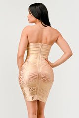 back view of A model wearing a gold, strapless, mini dress with sequins and bead embellishments, featuring a sweetheart neckline.