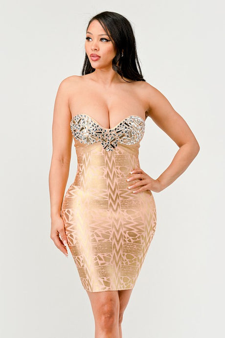 A model wearing a gold, strapless, mini dress with sequins and bead embellishments, featuring a sweetheart neckline.