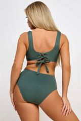 Green bikini set worn by a model on a white background back view