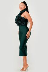 Woman wearing a green dress with floral details on a white background