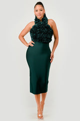 Woman wearing a green dress with a floral top on a white background