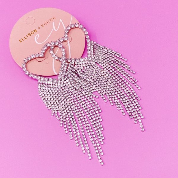 Sparkly tassel earrings on a pink background with 'Ellison + Young' card.
