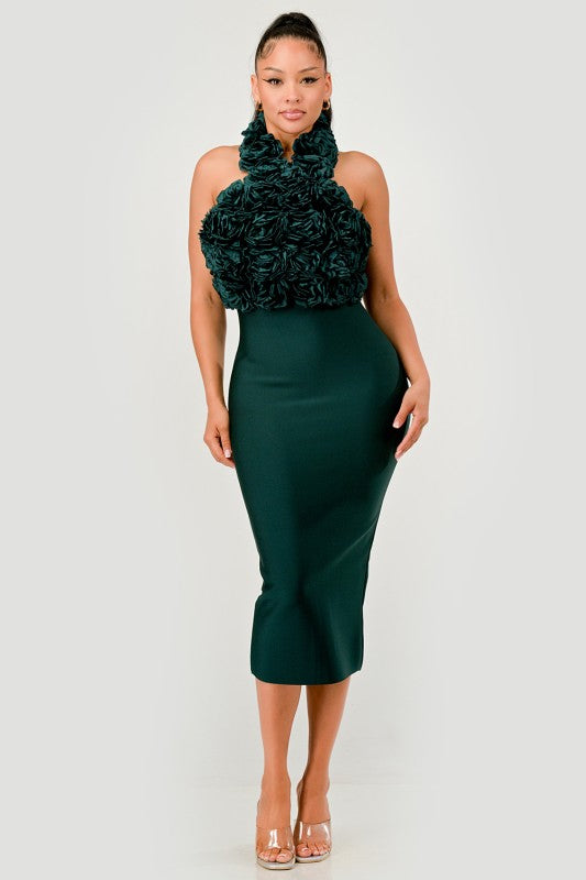 Woman wearing a green dress with floral top on a white background