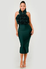 Woman wearing a green dress with floral top on a white background