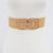 Beige woven belt on a mannequin with a white background