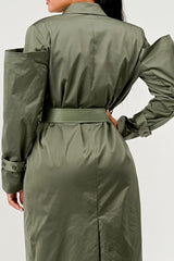 Green trench coat worn by a person on a white background