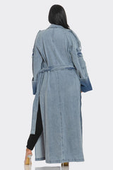 Denim trench coat worn by a person on a white background