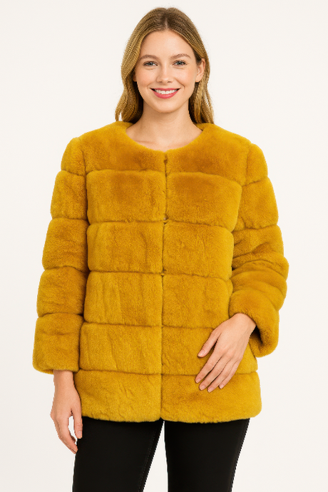 Woman wearing a mustard yellow fur coat on a white background