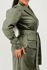 Person wearing a green trench coat on a white background