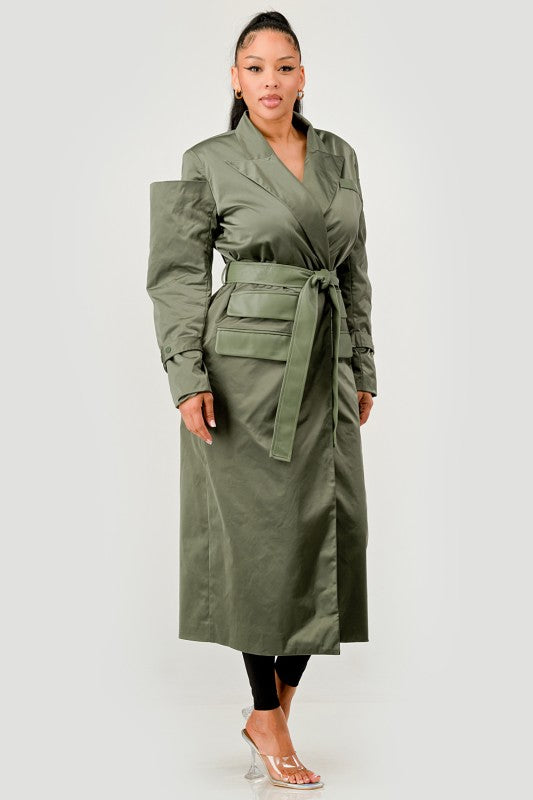 Woman wearing a green trench coat on a white background