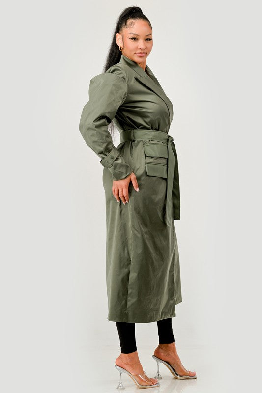 Woman wearing a green trench coat on a white background