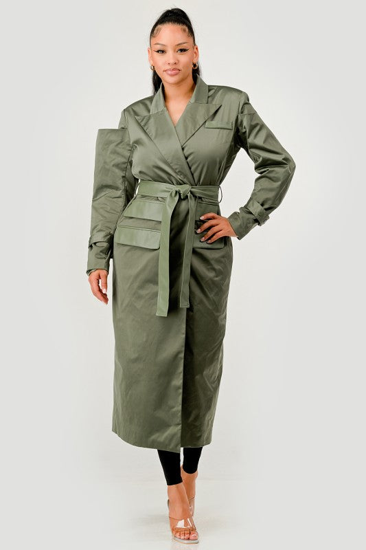 Woman wearing a green trench coat on a white background