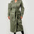 Woman wearing a green trench coat on a white background