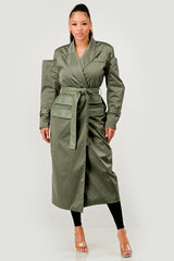 Woman wearing a green trench coat on a white background