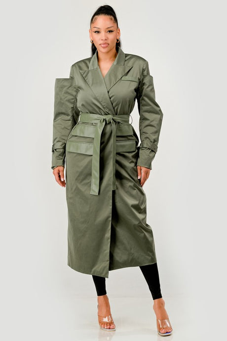 Woman wearing a green trench coat on a white background