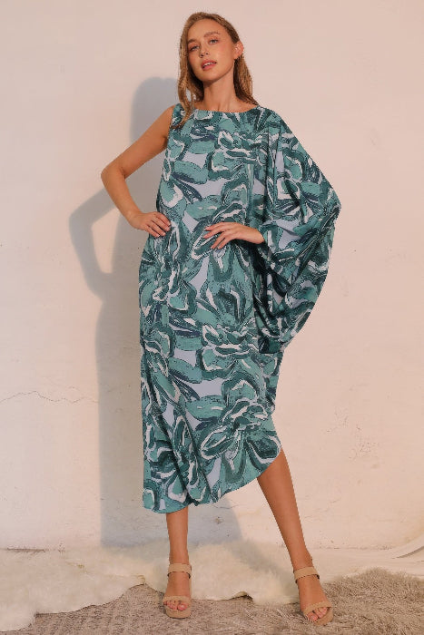 Woman wearing a green patterned dress against a white background