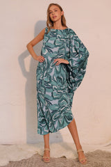 Woman wearing a green patterned dress against a white background