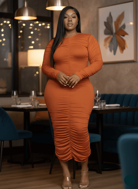 Woman in an orange dress standing in a restaurant setting