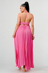 back view of Woman wearing a pink halter neck dress on a white background