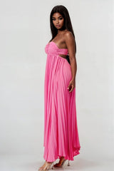 side view of Woman wearing a pink strapless gown on a white background