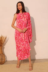 Woman wearing a pink floral dress against a plain background