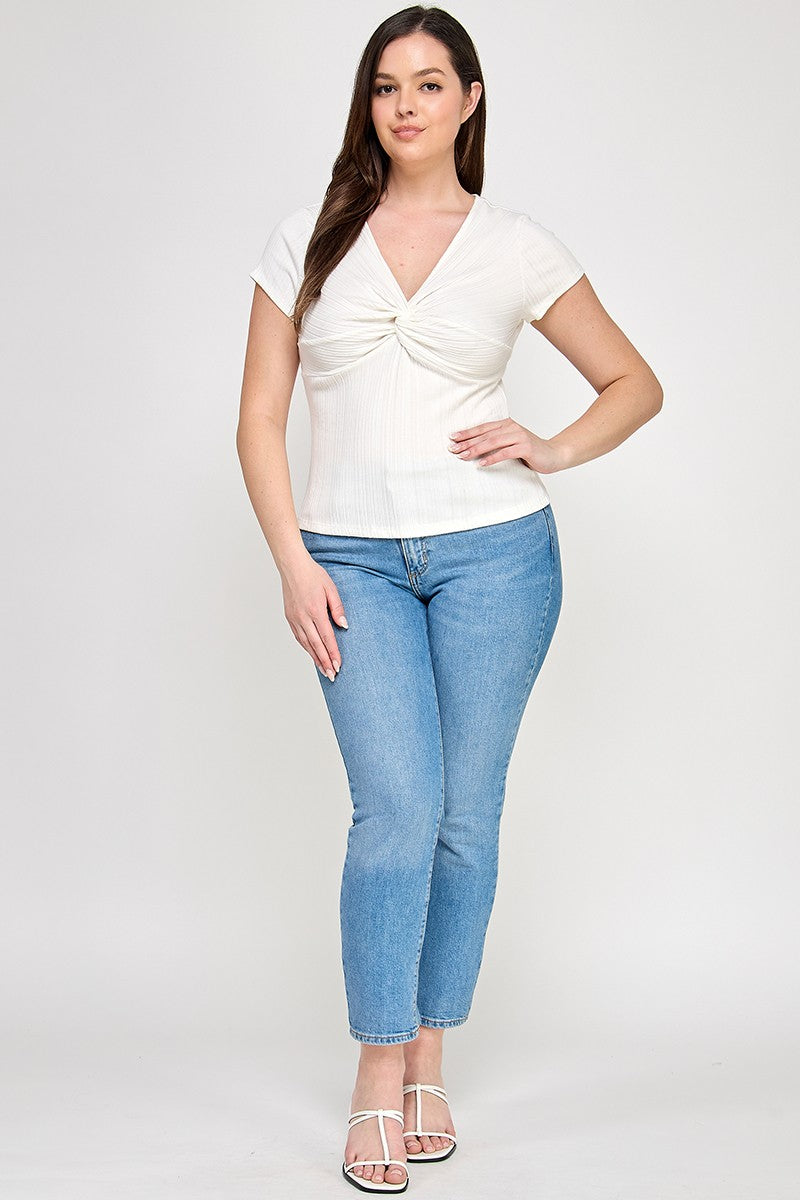 Woman wearing a white top and blue jeans on a white background