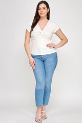 Woman wearing a white top and blue jeans on a white background