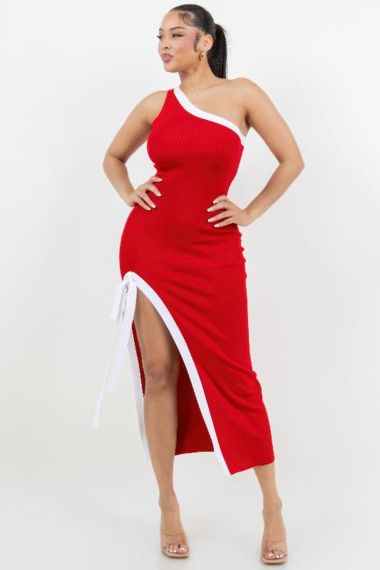 Woman wearing a red and white dress with a slit on a white background