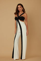 Woman wearing a black and white outfit with a beige background