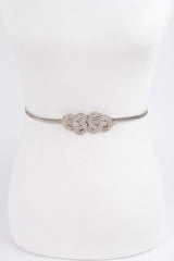 Silver belt with intricate design on a white background