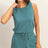 Woman wearing a teal Drawstring Waist Sleeveless Romper on a beige background