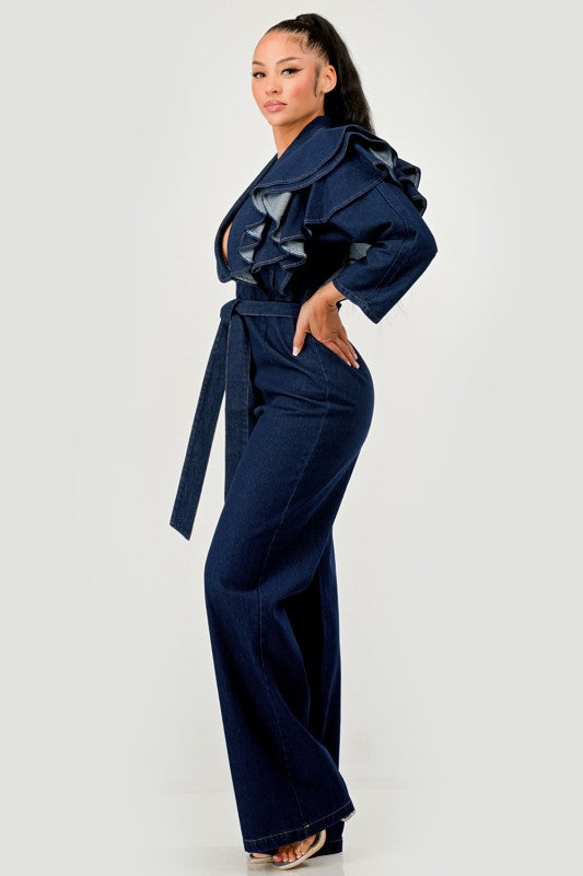 Woman wearing a denim jumpsuit with ruffles on a white background
