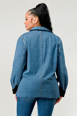 Woman wearing a blue denim jacket on a plain background